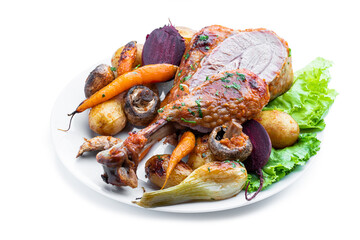 Oven roasted turkey and vegetables with spices and herbs isolated on white