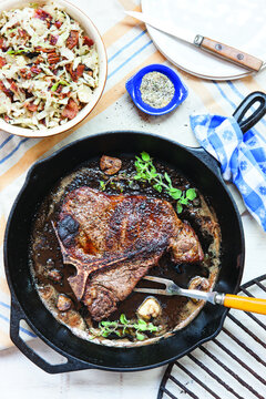 Overhead View Of Cooked Steak In Cooking Pan On Table At Home