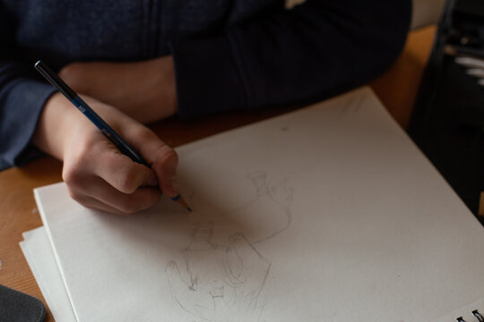 Close up of tween boy drawing comics