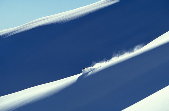Adult male backcountry skier skiing fresh powder at Rogers Pass, British Columbia, Canada.