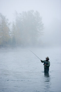 A man fly-fishing on Elk River, BC, Canada.