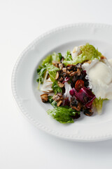 salad with herbs, mushrooms and poached egg