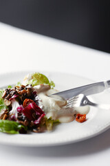 salad with herbs, mushrooms and poached egg