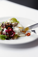 salad with herbs, mushrooms and poached egg