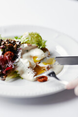 salad with herbs, mushrooms and poached egg