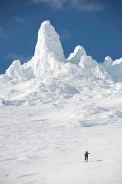 Skiers ascend the Northeast flanks of  Mt Augustine