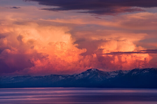 Alpenglow thunderheads at sunset over Lake Tahoe and the snow covered Sierra mountains