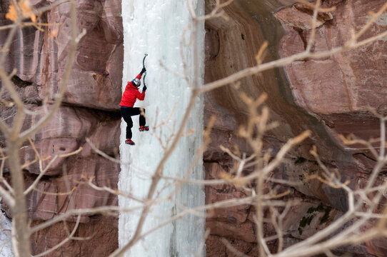 Man climbing ice pillar without a rope, Redstone, Colorado.