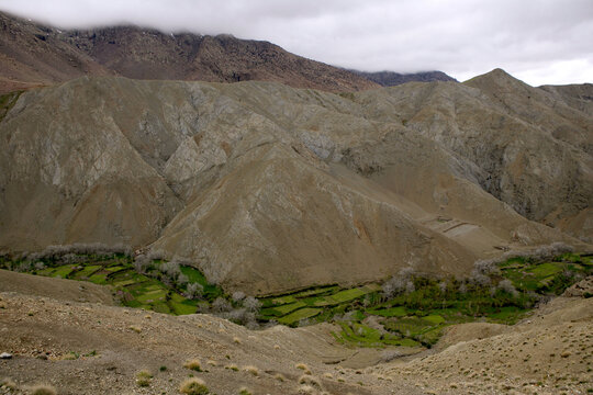Scenery with valley, mountains and fields at pass road between Ouarzazate and Marrakesh in High Atlas mountains