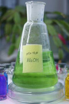 The sodium hydroxide solution is in the conical flask with indicator dye.
