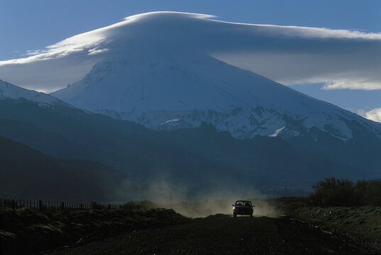 Car moving on a road, Lanin Volcano, Argentina