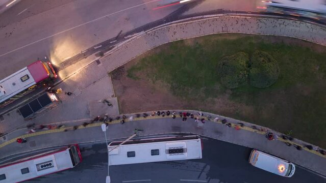 passengers in the queue for boarding the bus on a busy street at the end of the day, time lapse. High quality 4k footage