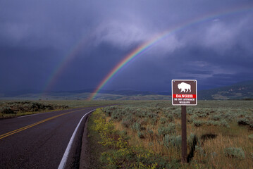 Double Rainbow over Road with "do not approach Wildlife" Bison sign, near Kelly, Grand Teon National Park, Wyoming, USA