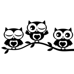 three funny owls silhouettes on a branch
