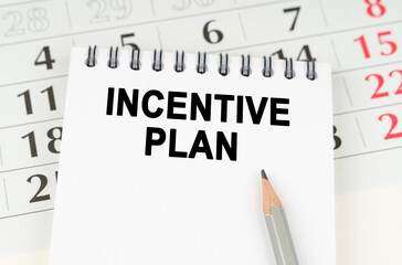 On the calendar is a notebook with the inscription - INCENTIVE PLAN