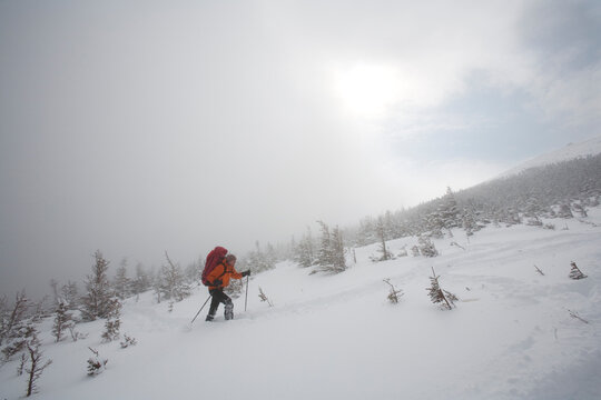 A man hiking through the snow on Mt. Washington.