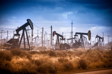 A nodding donkey pumps crude up from the ground on an oil field.