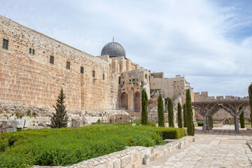 Ancient temple walls making up the Temple Mount in Jerusalem. Fakhriyya minaret and Al-Aqsa Mosque atop the Temple Mount.