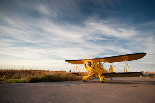 Old yellow bi-plane on the runway