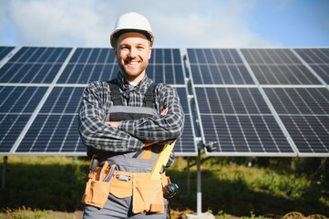 Solar power plant worker checks the condition of the panels