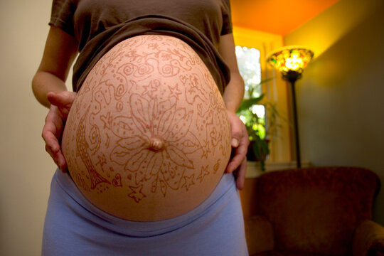 Pregnant woman with decorated belly
