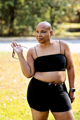Bald Black woman outside