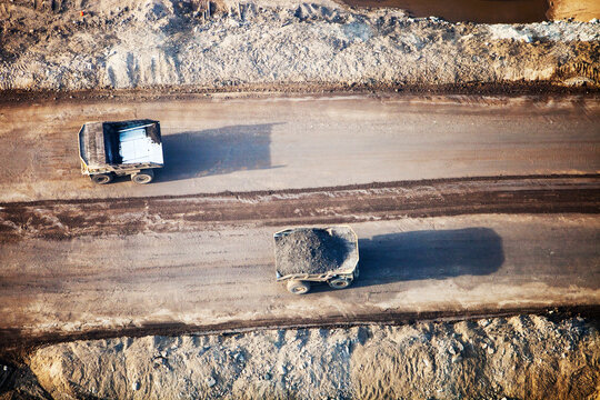 Massive dump trucks loaded with tar sand in a mine north of Fort McMurray, Alberta, Canada.