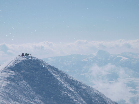 Skiers on top of the Annupuri mountain, a volcano in Niseko, Japan.