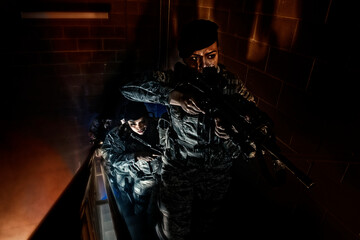 An Air Force Security Forces squad clear the stairwell of a training building during a simulated hostage situation.
