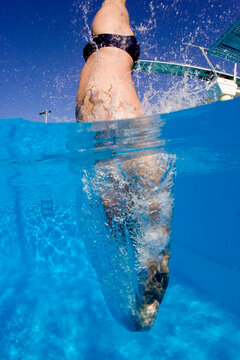 Diver jumping from springboard and entering water, Key Largo, Florida