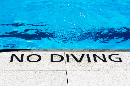 No Diving sign at the waters edge, The Floating Pool at Brooklyn Bridge Park Beach, NY.