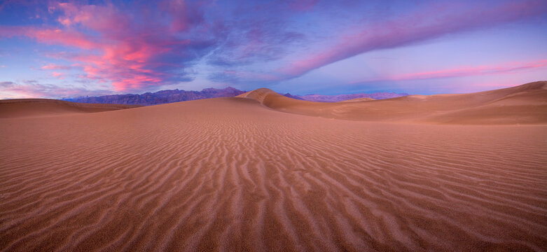 Sand Dunes rolling through the land in Death Valley National Park, California at sunset