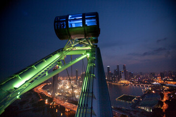 The Singapore Flyer, a 42 story high observation wheel, built to give tourists a 360 degree view of Singapore during a 30 minute "flight" in the safety and comfort of individual ai