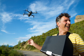 A man driving a drone in the Pyrenees.