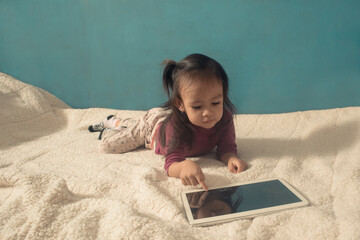 little girl playing tablet pc