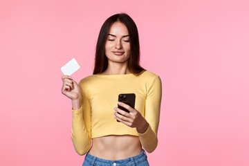 woman in yellow clothes holding plastic credit card