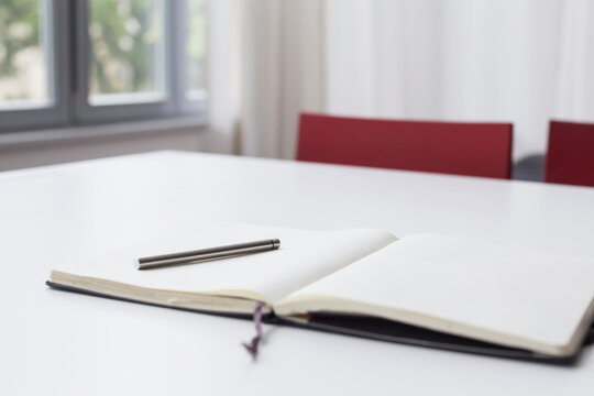 Notebook and pen on table, close up