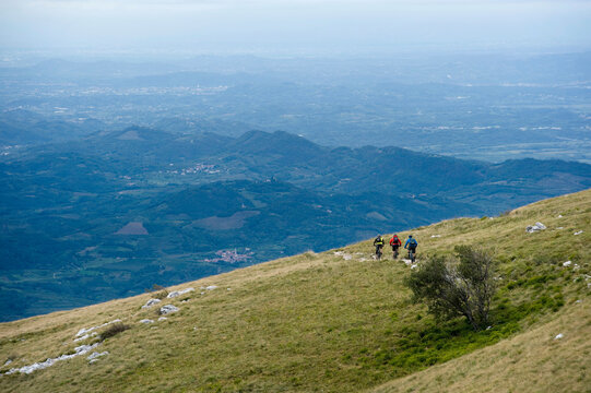 three mountain bikers on the way downhill, Vipava valley, Istria, Nanos, Slovenia