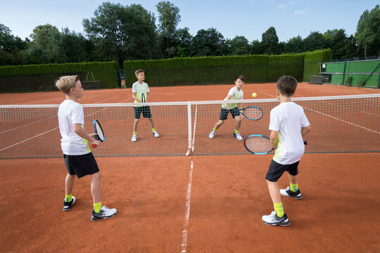 Young boys playing tennis, Bavaria, Germany