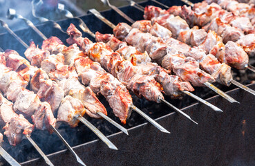 Cooking traditional shish kebab or shashlik on metal skewers
