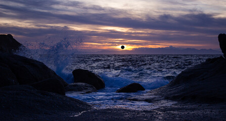 Marine scenic sunset with solar eclipse in the distance.