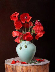 Poppies in a vase against a dark background