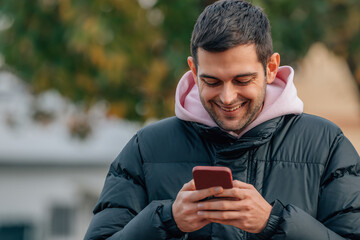 young man with mobile phone outdoors