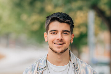 portrait of young man with beard outdoors