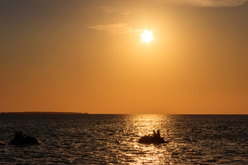 Silhouette of personal watercrafts in the Indian ocean at sunset in Zanzibar, Tanzania