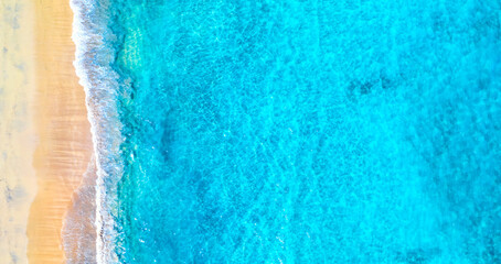 Top view aerial drone photo of ocean seashore with beautiful turquoise water and sea waves. Caribbean resort. Vacation travel background.