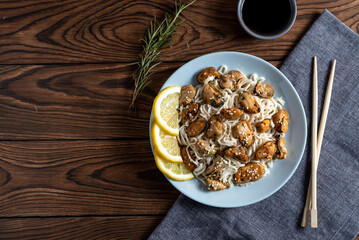 mussels with noodles boiled in a plate with spices on a wooden background