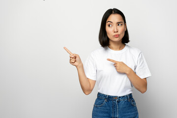 Serious confident bossy woman pointing fingers, making choice, thinking