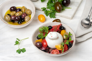 burrata cheese salad with tomatoes, olives and olive oi