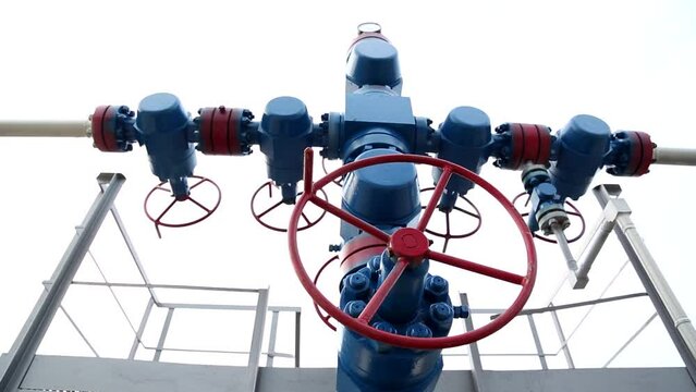 Large blue refinery pipes with flanges and valves to transport fuel